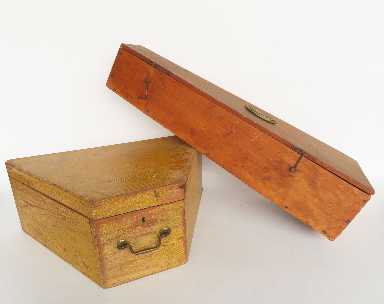 Two wooden boxes. The first, in mustard grain paint, probably a hat box with bale pull, early 19th (1 of 9)