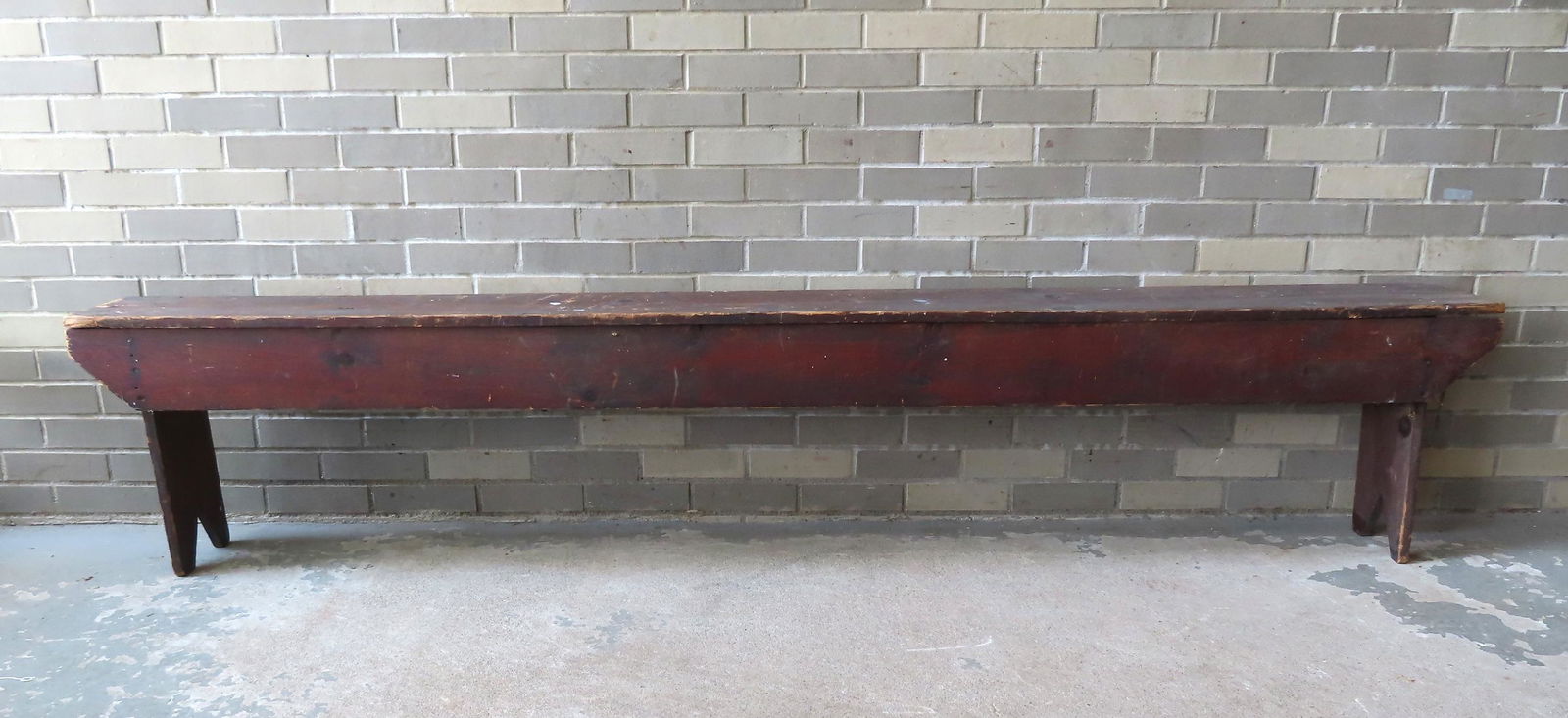 A primitive pine meeting house bench in original brown stain having bootjack ends, and square nail (1 of 9)