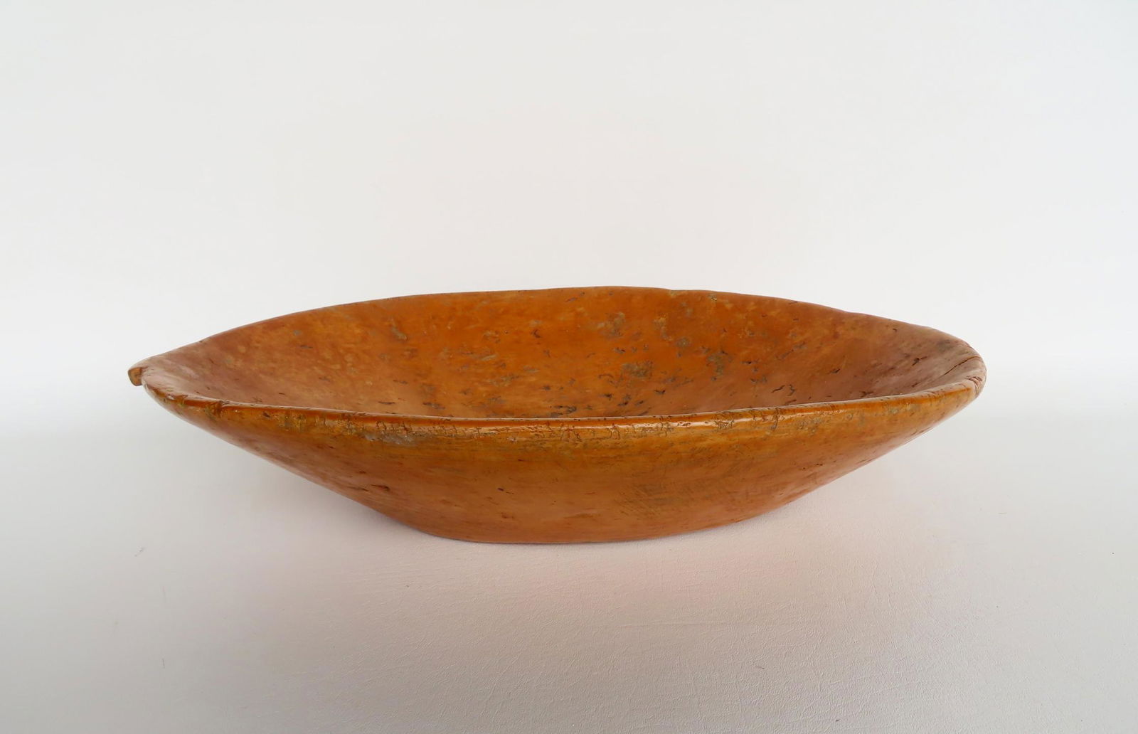 A primitive carved wooden trencher, probably late 19th century, with carved handles on each end. (1 of 8)