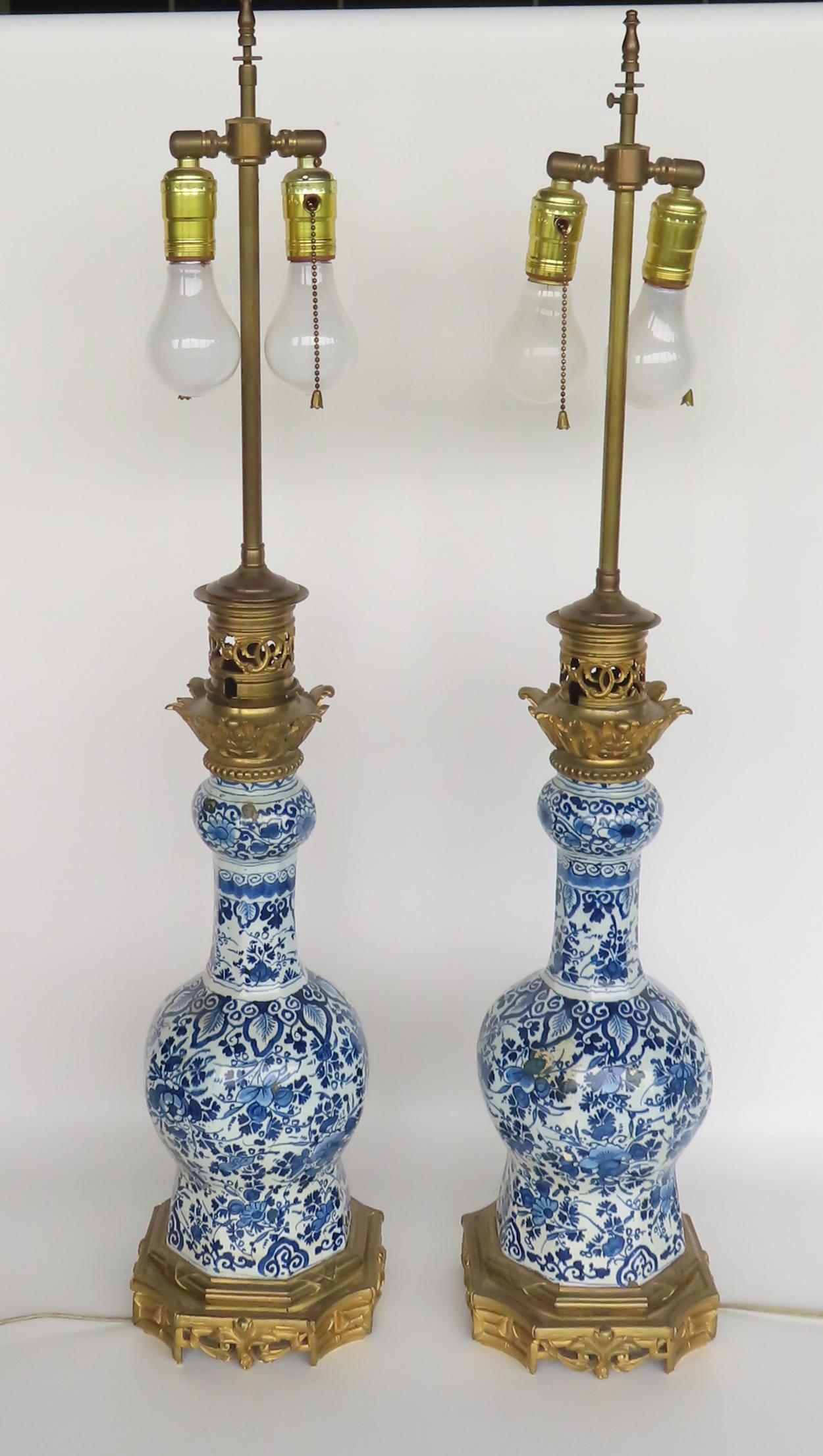 A pair of Dutch delft blue and white table lamps mounted on a gilded metal base - both with matching (1 of 13)