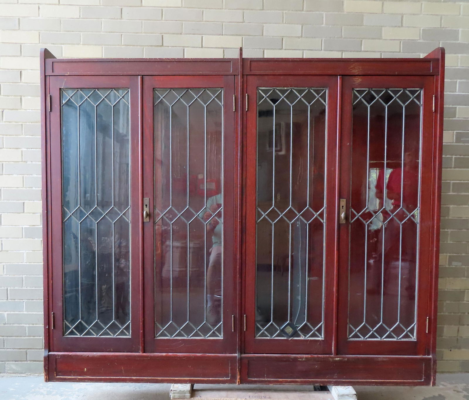 A large 4 door leaded glass bookcase. The wood appears to be birch stained a mahogany color. One (1 of 13)