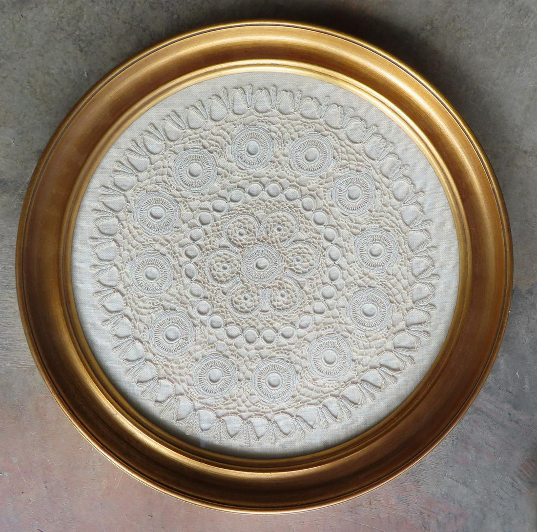 A framed white embroidery, early 20th century. Very good condition. The frame measures 19 1/2": A framed white embroidery, early 20th century. Very good condition. The frame measures 19 1/2" diameter.
