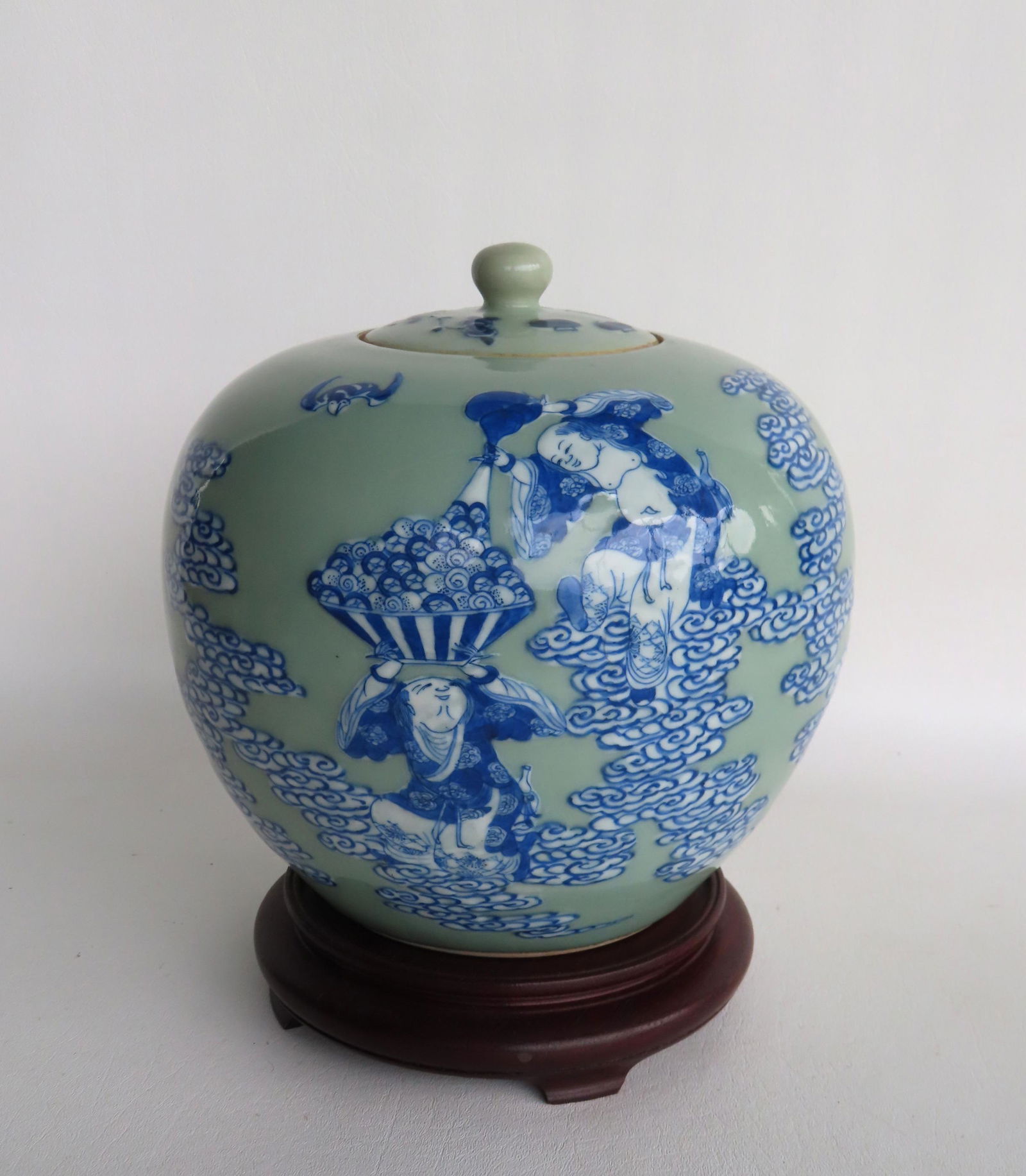 A Chinese ginger jar decorated in blue and white with figures and flying bats, on a celadon ground, (1 of 8)
