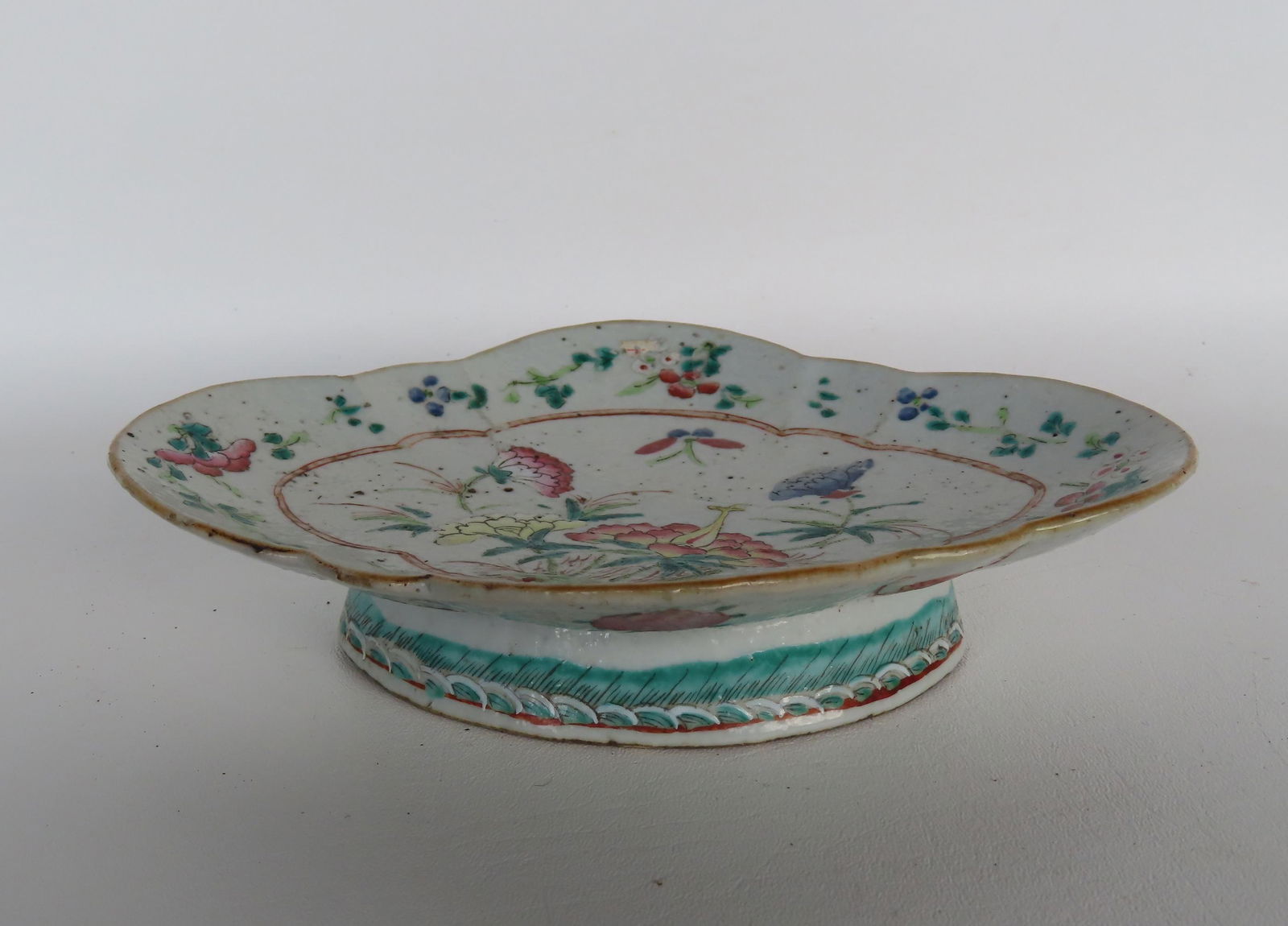 A small Chinese export footed and shaped serving platter decorated with colorful flowers on interior (1 of 4)