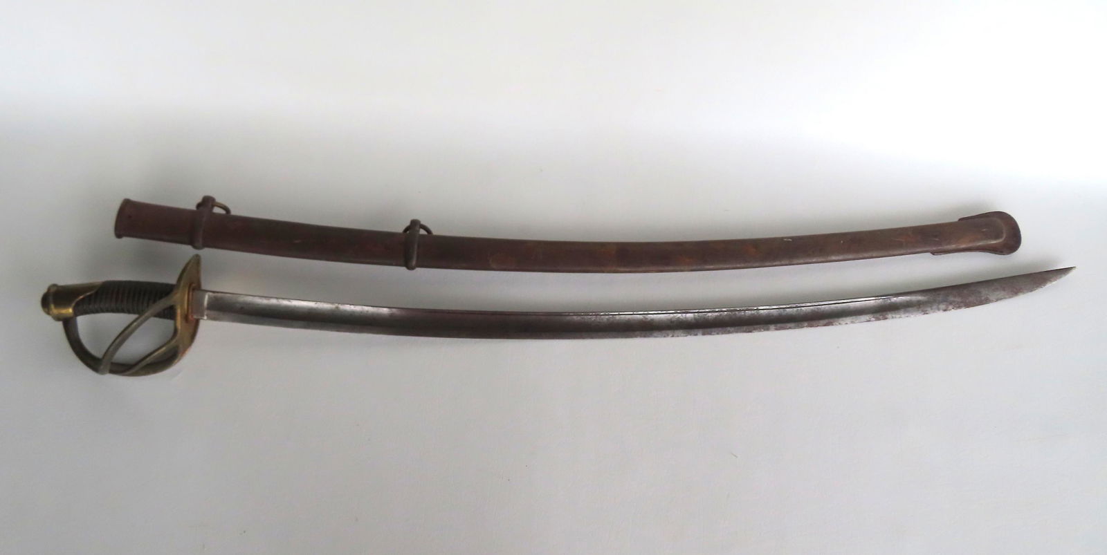 Two vintage swords. The first a Civil War cavalry sword, signature partially obscured by leather (1 of 20)