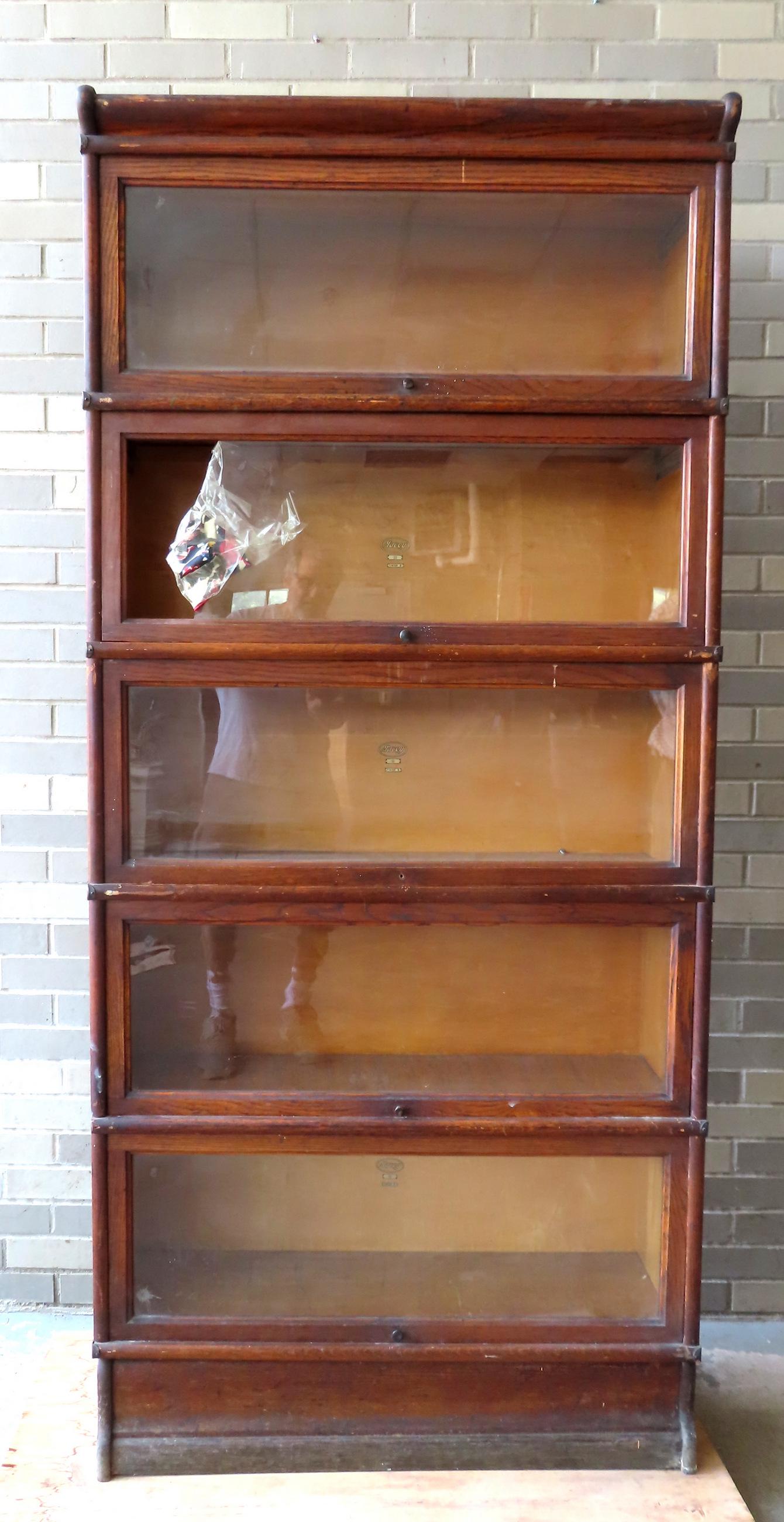An oak "Macey 911" 5 section stacking bookcase, complete but missing 1 door pull, one door with (1 of 9)