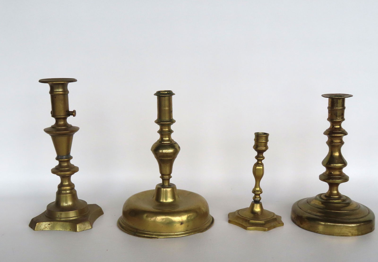 Grouping of 4 early brass candlesticks, all 18th to early 19th century. The largest, with an unusual (1 of 9)