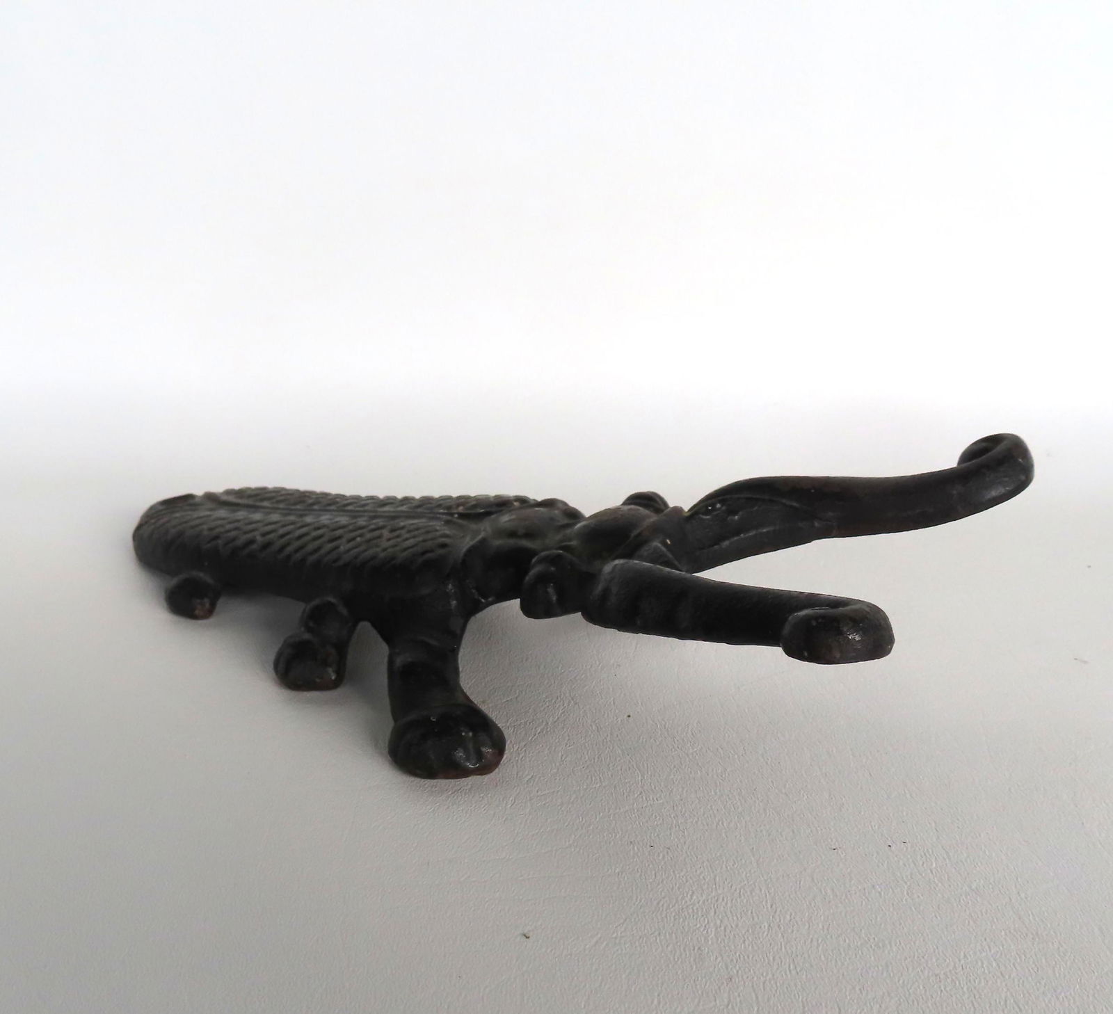 A cast iron beetle form boot scraper in original black paint with original paper label on reverse (1 of 5)