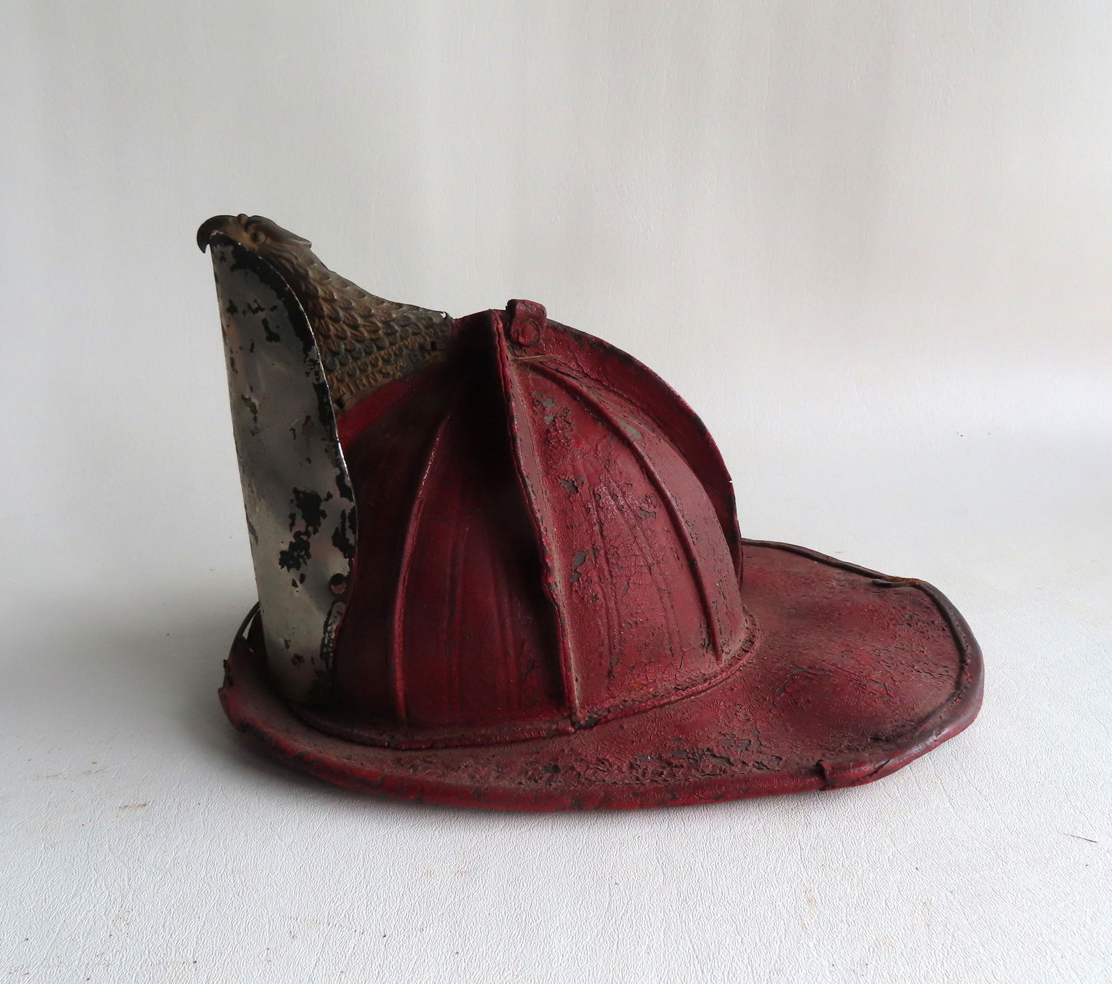 A vintage Cairns Brothers leather fireman's helmet in old red paint, 19th c. (1 of 8)