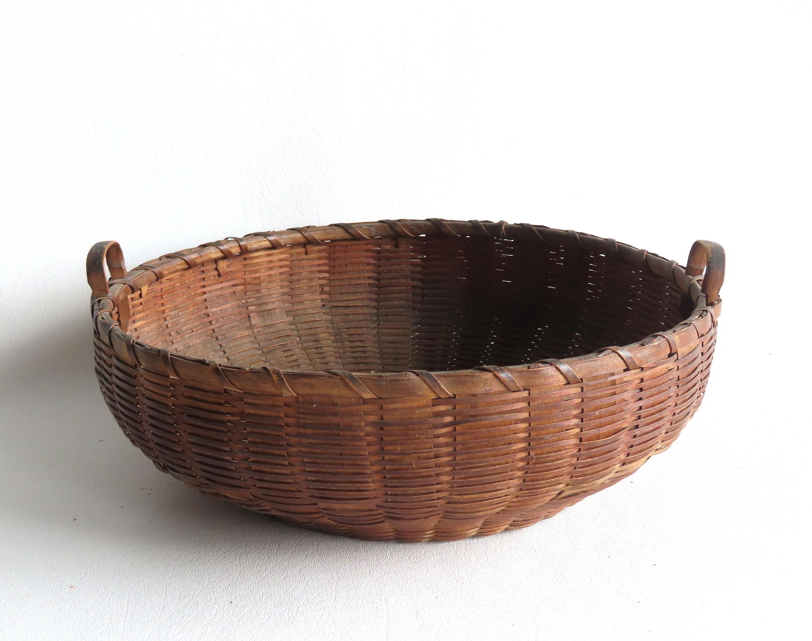 A primitive basket with delicate carved handles and single wrap on rim - several small splint breaks (1 of 9)