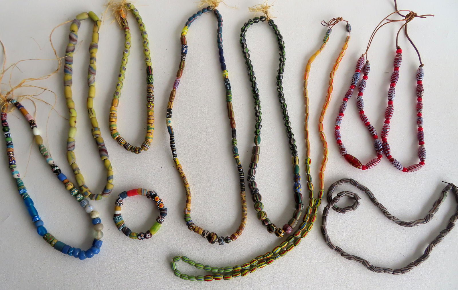 Grouping of 8 colorful indigenous peoples beaded necklaces, one with matching bracelet. Most appear (1 of 4)