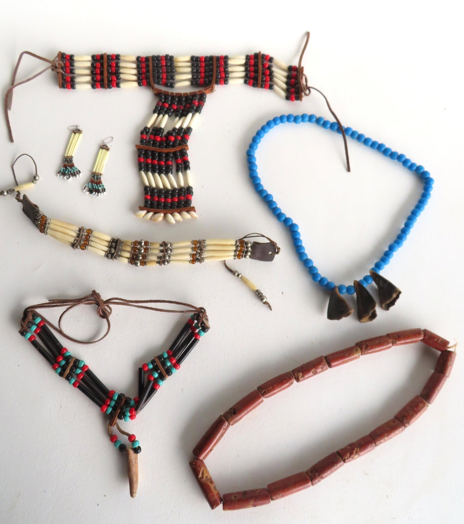 Grouping of 5 indigenous peoples hand made beadwork necklaces, some possibly Native American, plus a: Grouping of 5 indigenous peoples hand made beadwork necklaces, some possibly Native American, plus a pair of porcupine earrings. The necklaces constructed of bone, silver, and stone - probably mid to