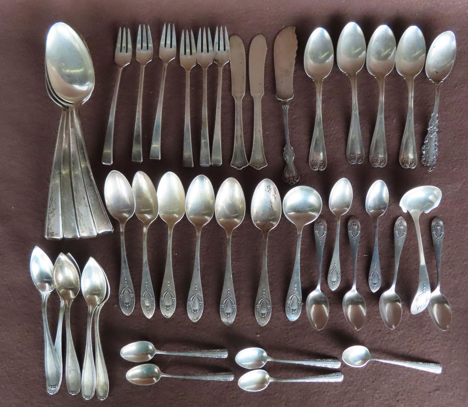 Grouping of 42 sterling flatware pieces including: 4 large dinner or serving spoons; 4 Tiffany & Co. (1 of 10)