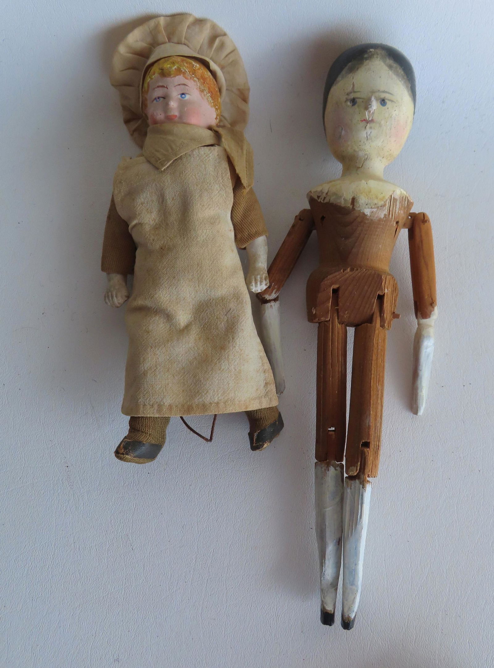Two hand painted 19th century dolls. The first a hand painted peg doll - the head and shoulders in (1 of 4)