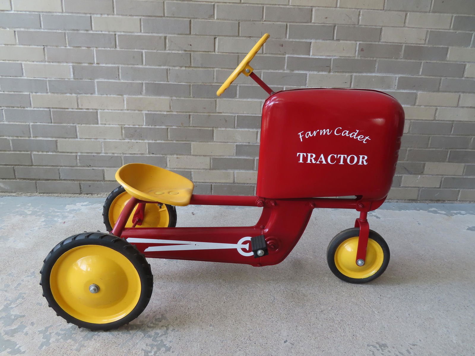Peddle tractor signed "Farm Cadet", in newer red and yellow paint with white stenciling, totally (1 of 5)