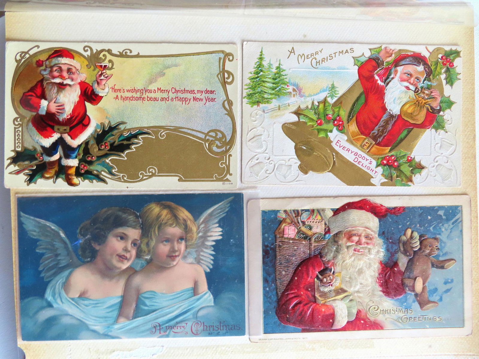 A postcard album containing 100 Christmas and New Years postcards (most are Christmas cards), early (1 of 18)