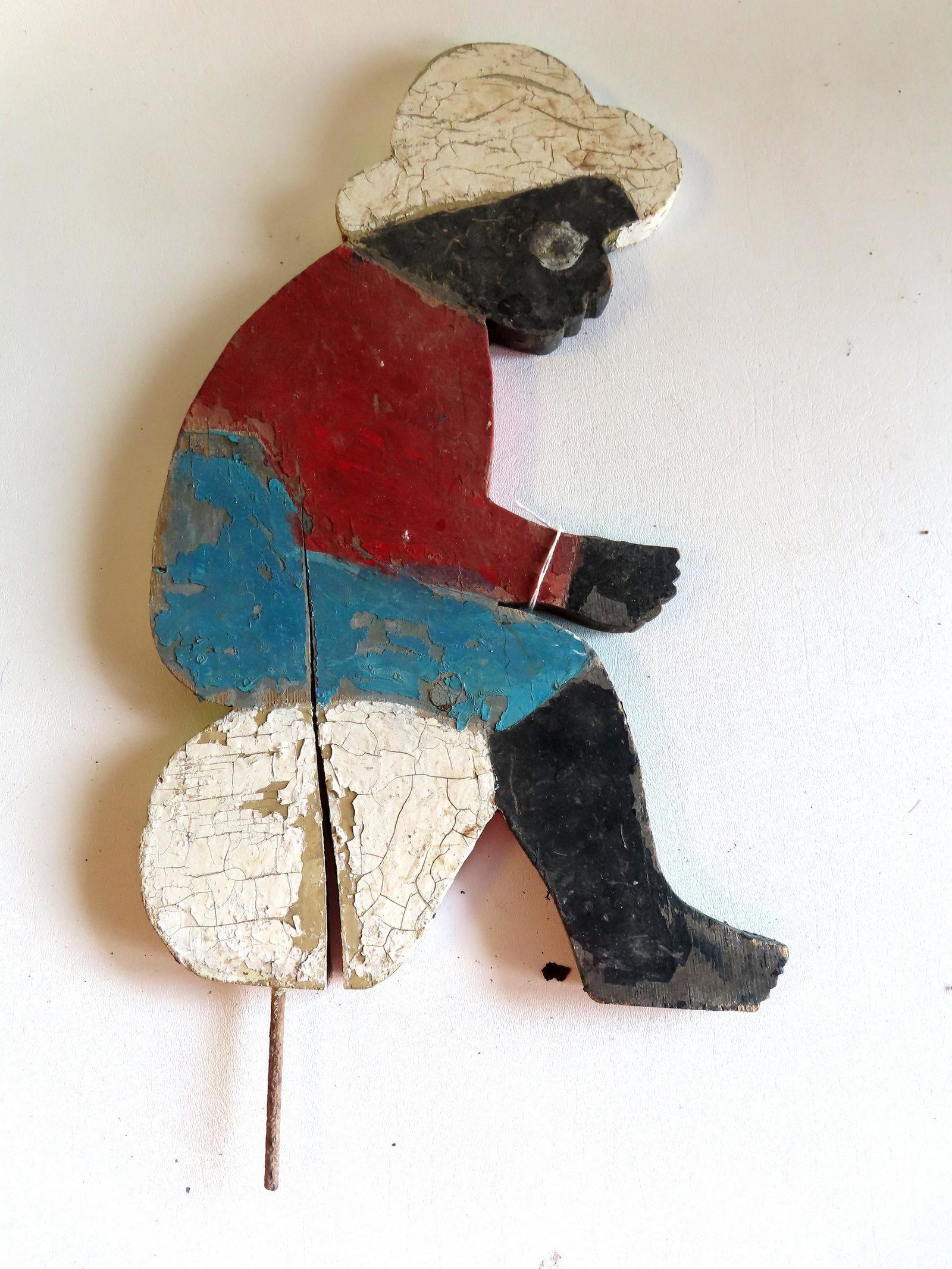 A hand made wooden lawn ornament.: A hand made and painted lawn ornament, remnants of original paint, probably held a fishing pole that is missing, circa 1950. Paint wear and expansion cracks. Measures 21"H x 11"W.