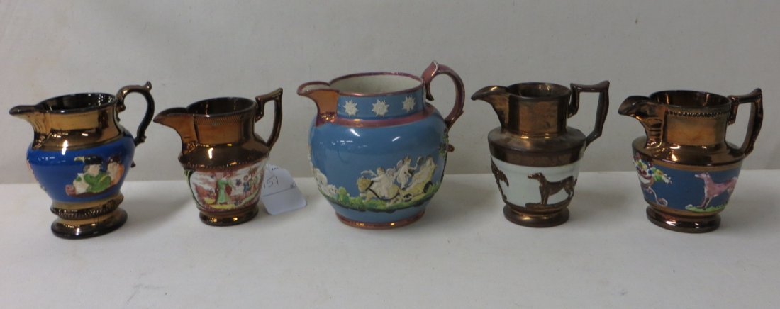 Five lusterware pitchers decorated with bulls, dog: Five lusterware pitchers decorated with bulls, dogs, people, cherubs on cart. Ranging in size from 4.5" to 6"H.