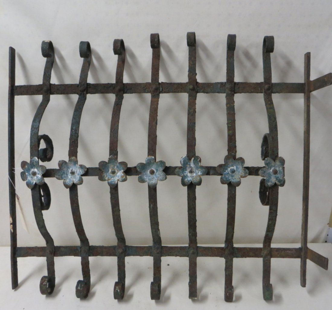 Cast iron window grate with applied white flowers: Cast iron window grate decorated with applied painted white cast iron flowers.30.5"L x 25.5"H. 19th century.
