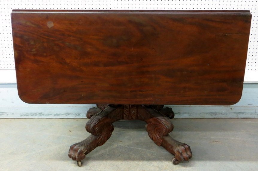 Classic Empire Mahogany drop-leaf breakfast table : Classic Empire Mahogany drop-leaf breakfast table having a heavily carved acanthus pedestal and heavily carved and shaped hairy paw legs. 38.25"L x 28.5"H - each leaf approx. 15.5"L. Provenance: Estat