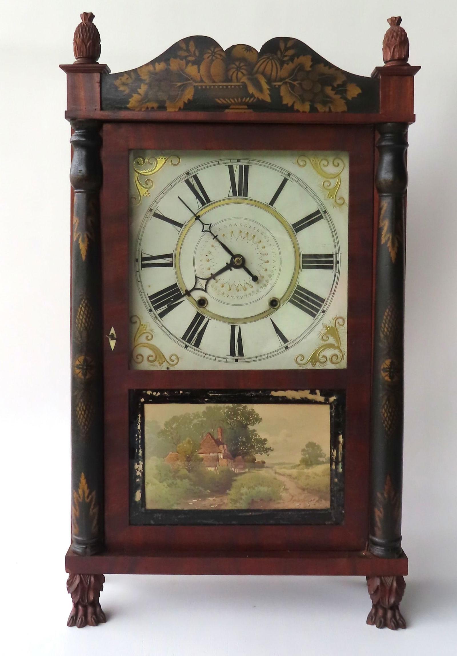 A stenciled shelf clock with 1/2 turned columns flanking the single door - the stenciled crest is (1 of 11)