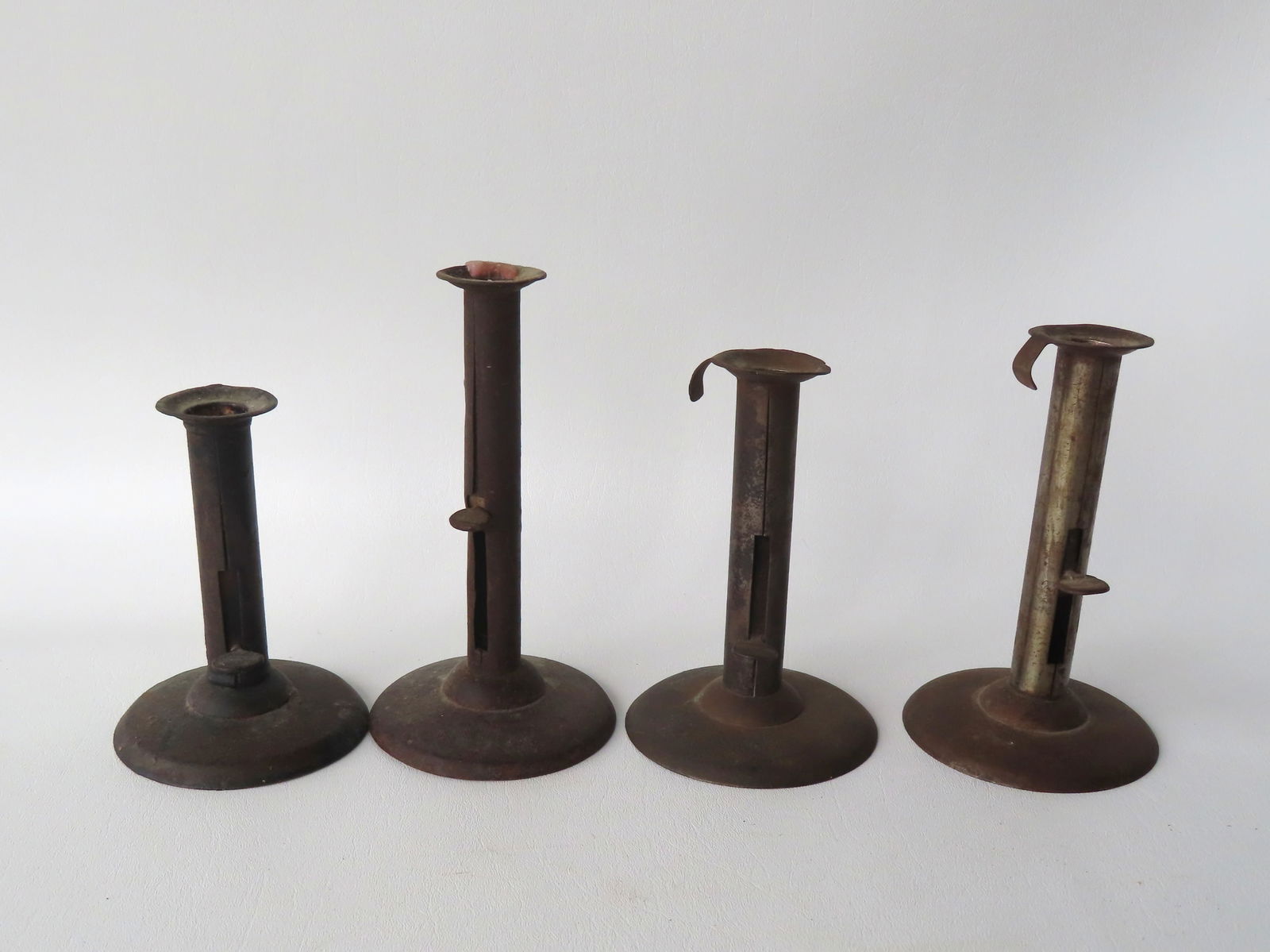 Grouping of 4 original tin hog scrapper pushup candlesticks, all in good condition, early 19th (1 of 4)