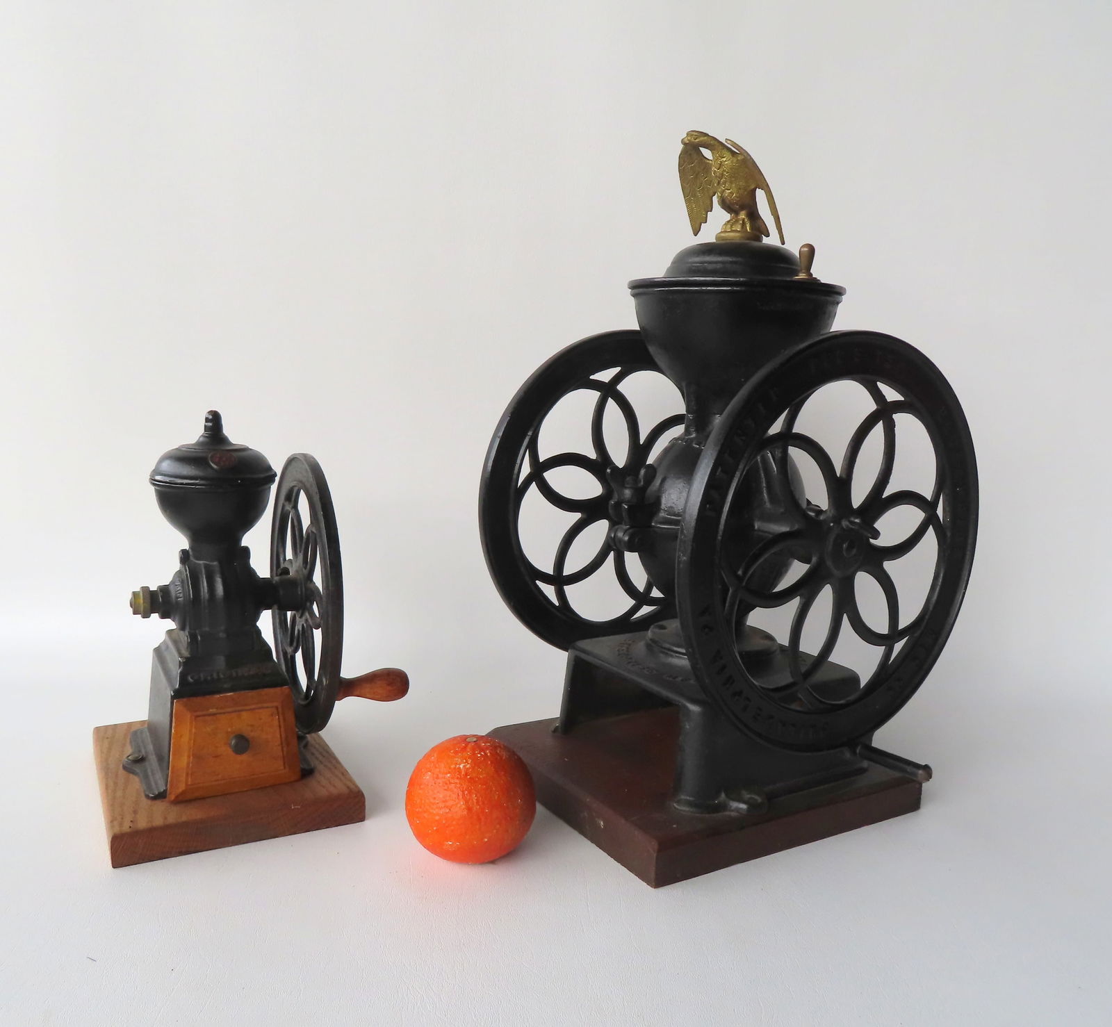Two cast iron coffee mills. The first, a double wheel signed Enterprise Mfg Co. with an eagle finial (1 of 11)