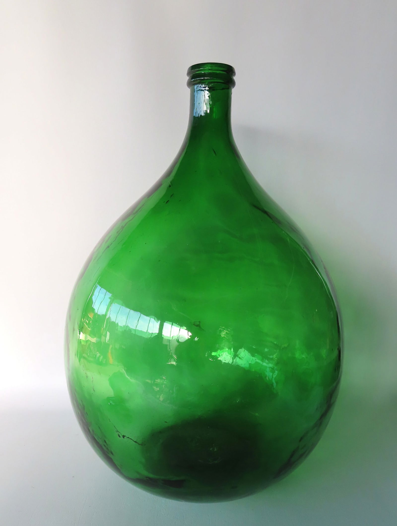 A large green demijohn bottle, some small bubble bursts and surface scratches, else good condition. (1 of 6)