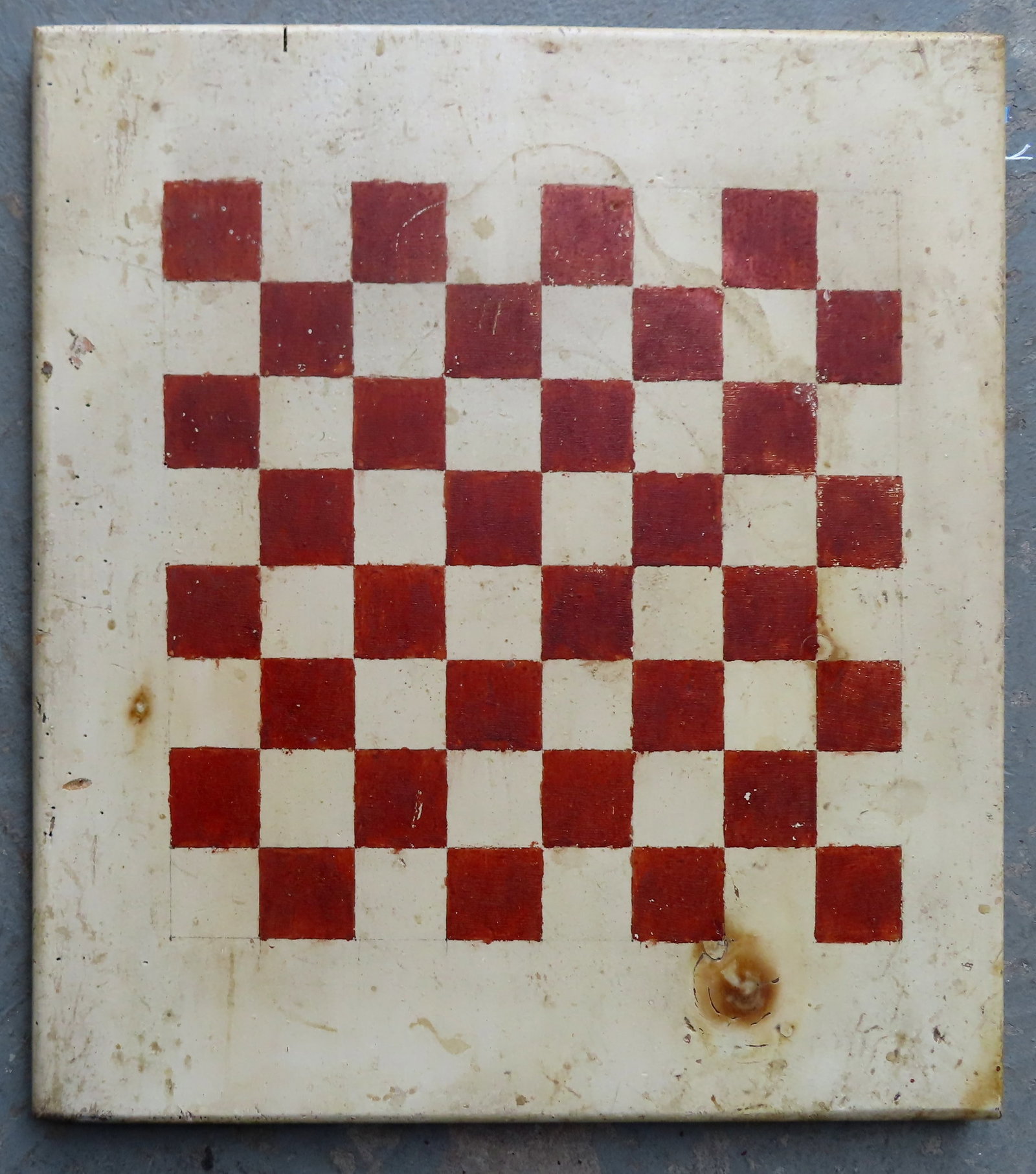 A game board with red and white squares on white ground, very good condition in original paint, late: A game board with red and white squares on white ground, very good condition in original paint, late 19th century. Measures 16" x 17 3/4".