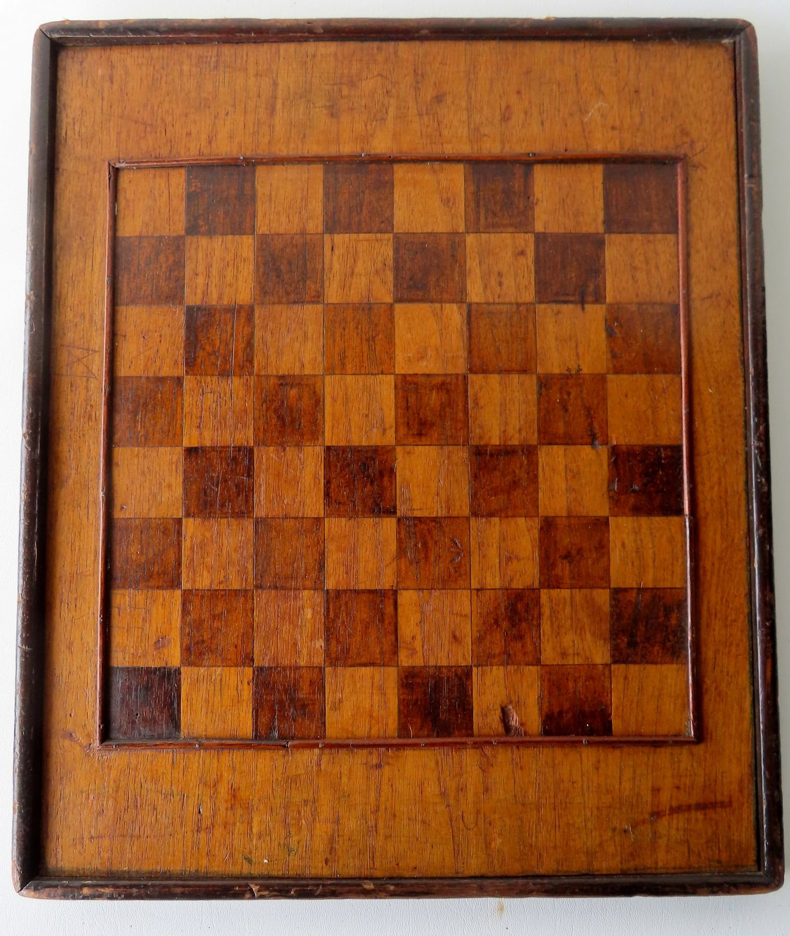 An inlaid butternut gameboard with applied molded border, 19th century, very good original: An inlaid butternut gameboard with applied molded border, 19th century, very good original condition. Measures 15 1/2" x 18 1/2". Provenance: From a Rochester NY estate, name withheld by family.