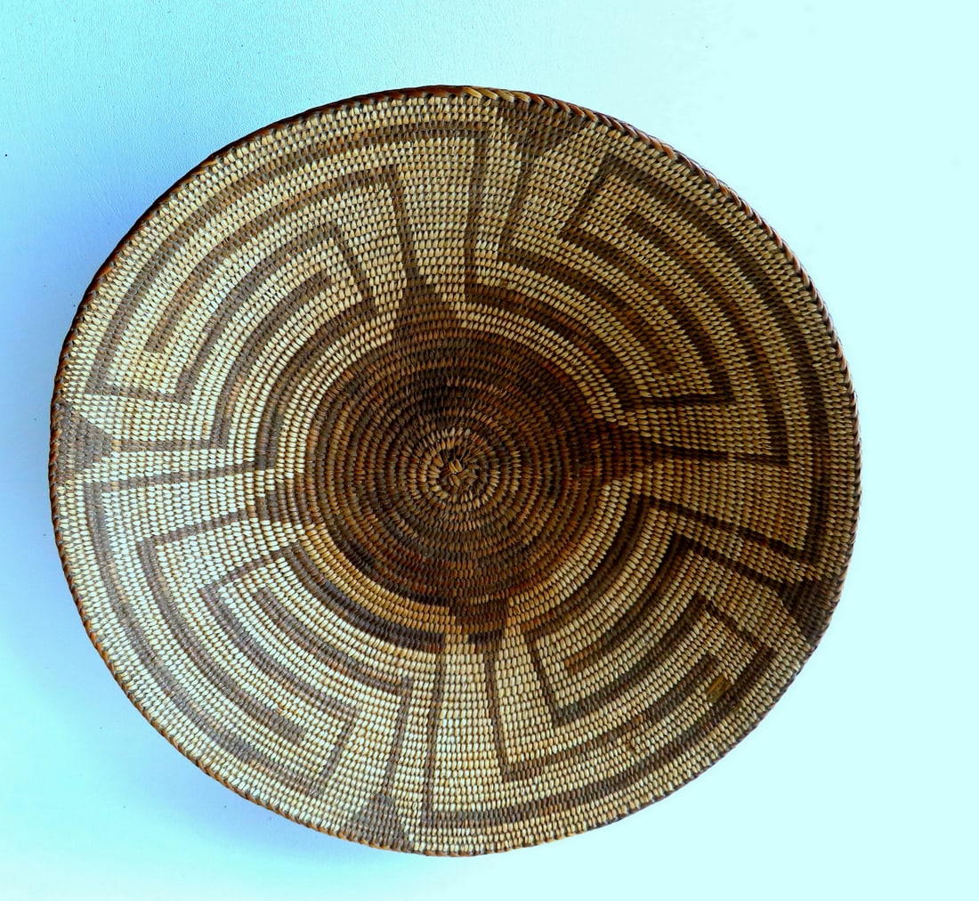 A very fine large Native American Pima basket, with herring bone woven rim, star center, and bear: A very fine large Native American Pima basket, with herring bone woven rim, star center, and bear grass rods (warps) - very tight weaving. One small area with exposed bear grass, else very good condit