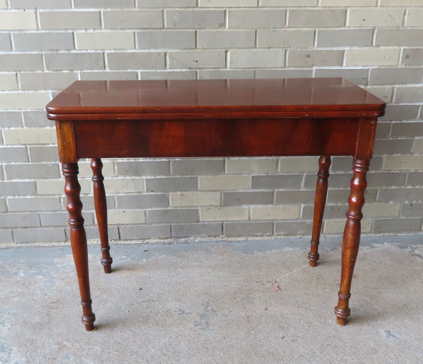 A Sheraton cherry card table with flip-top lid and turned legs, circa 1820-30. Refinished with some (1 of 8)