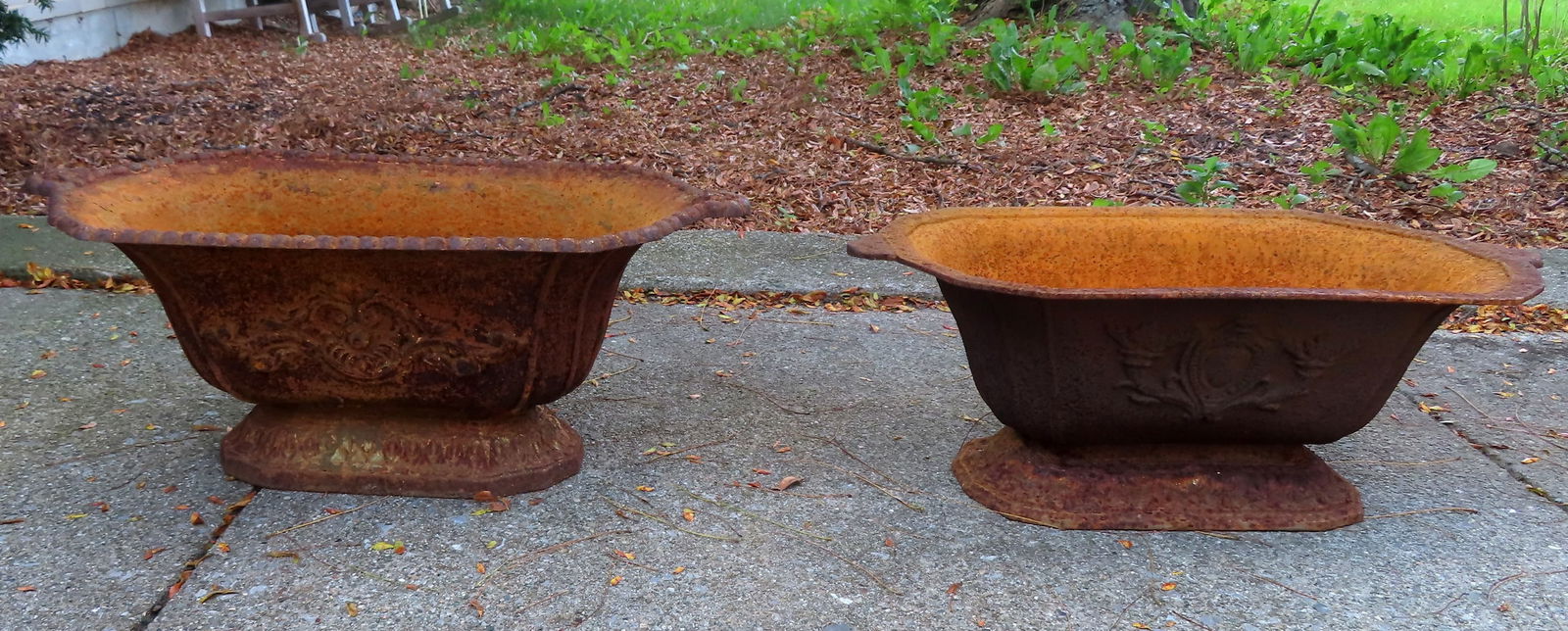 A pair of near matching cast iron flower boxes, with decorated fronts and side handles, mid 20th (1 of 9)