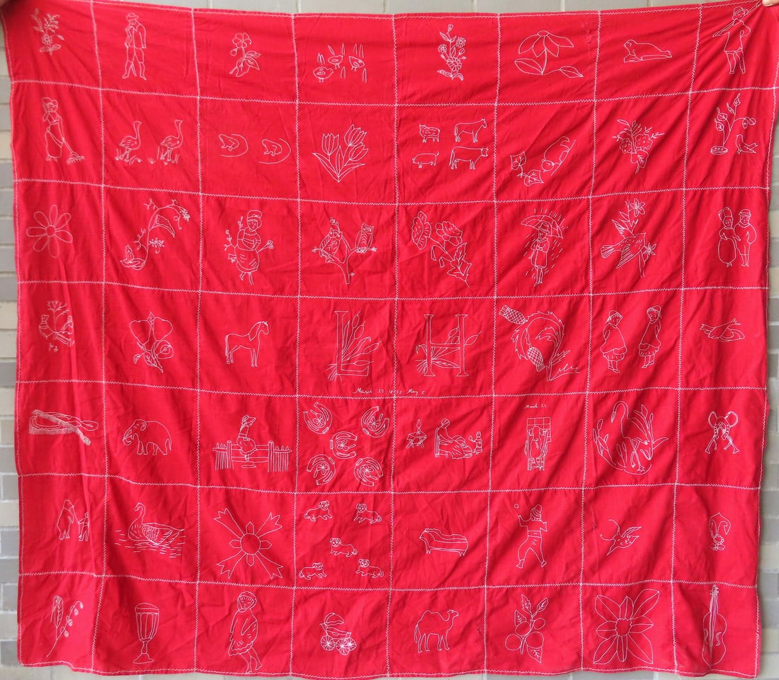 Two child's embroidered quilts with white stitches on red cotton fabric. The first a youth size (1 of 8)