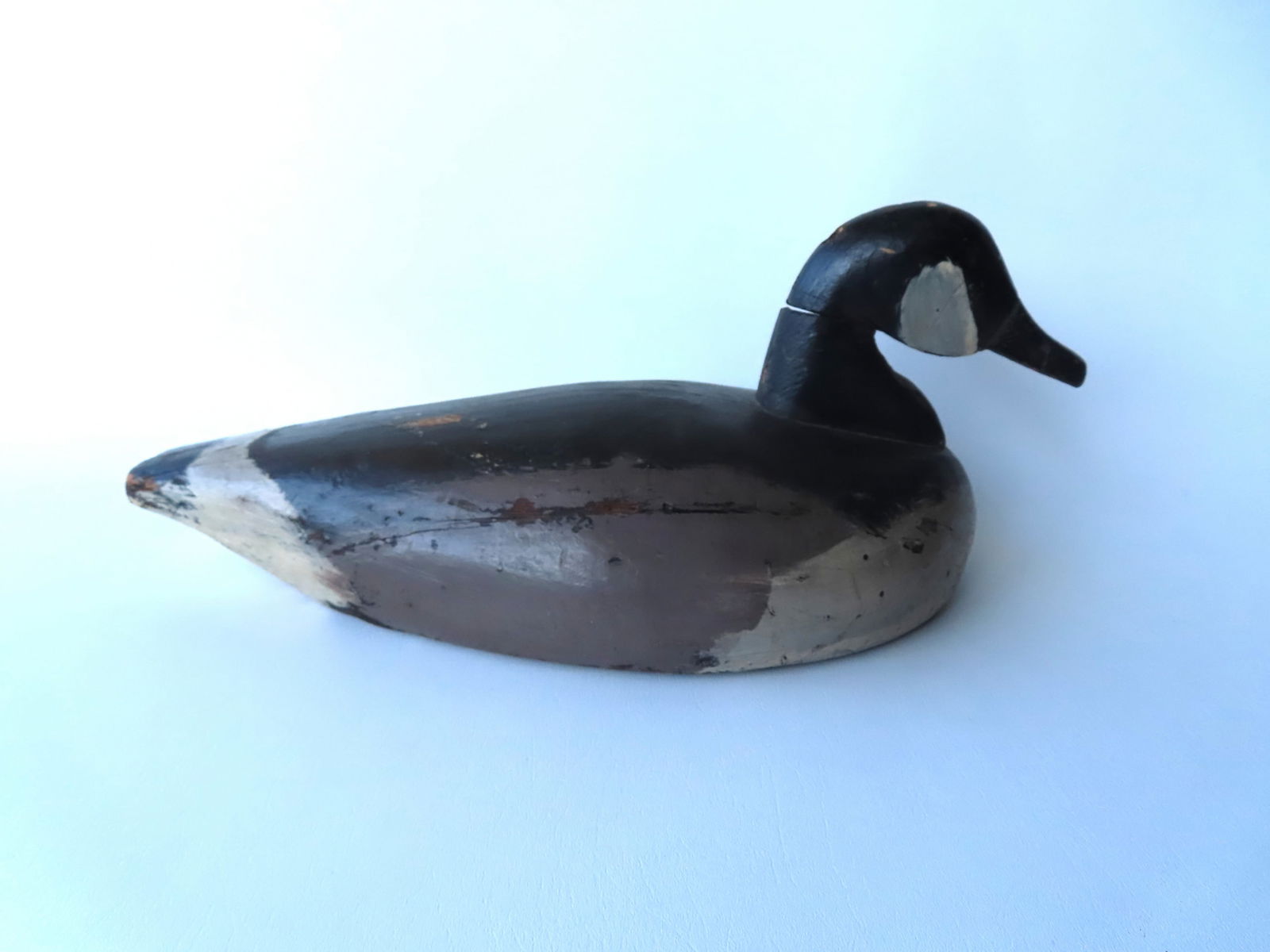 A primitive carved wooden goose decoy in original paint - split in neck and hairline on side of (1 of 6)