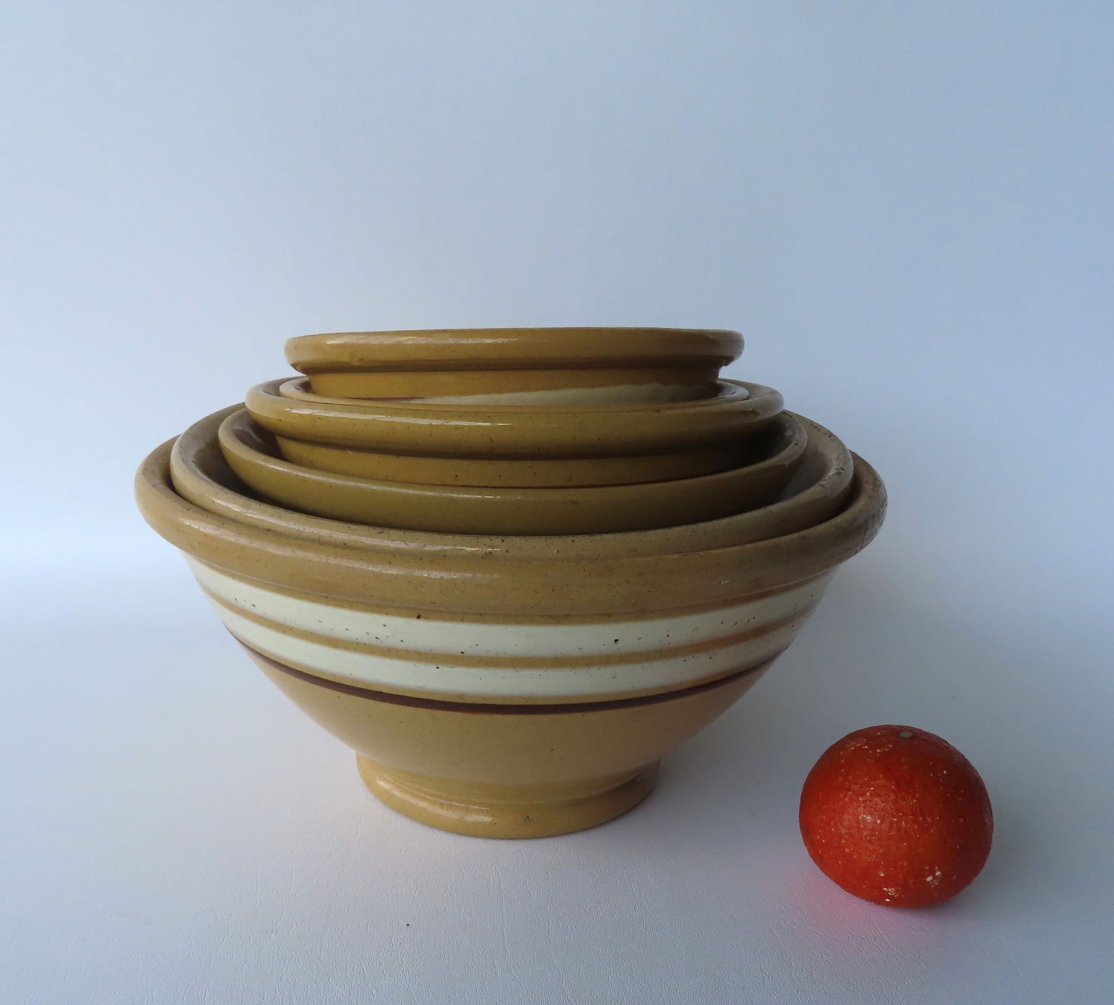 Grouping of 6 yellowware mixing bowls, various colored bandings. The largest measures 13" diameter x (1 of 16)