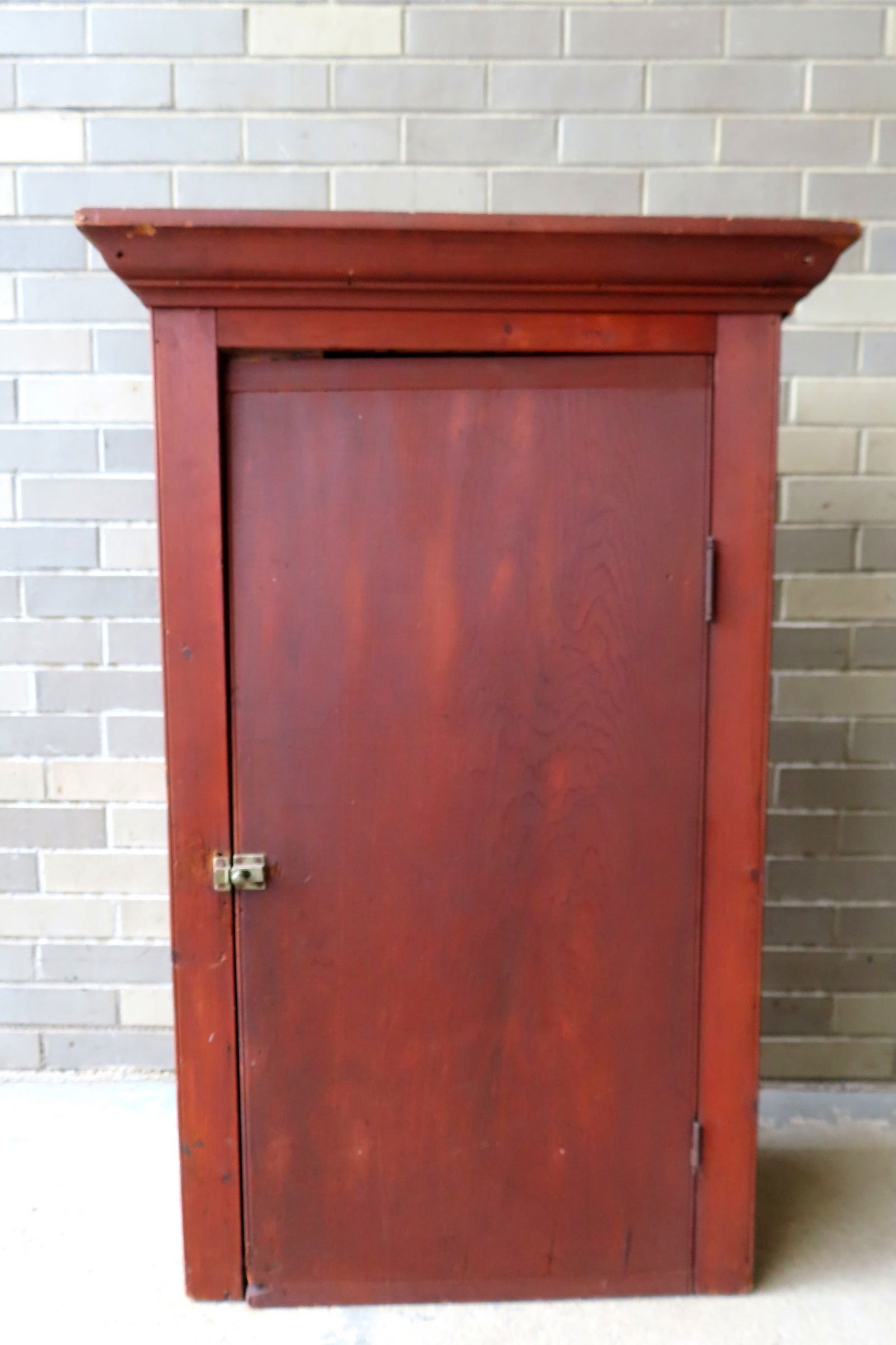 A hanging single door wall cupboard with cornice in original red stain, mid to late 19th century. (1 of 15)