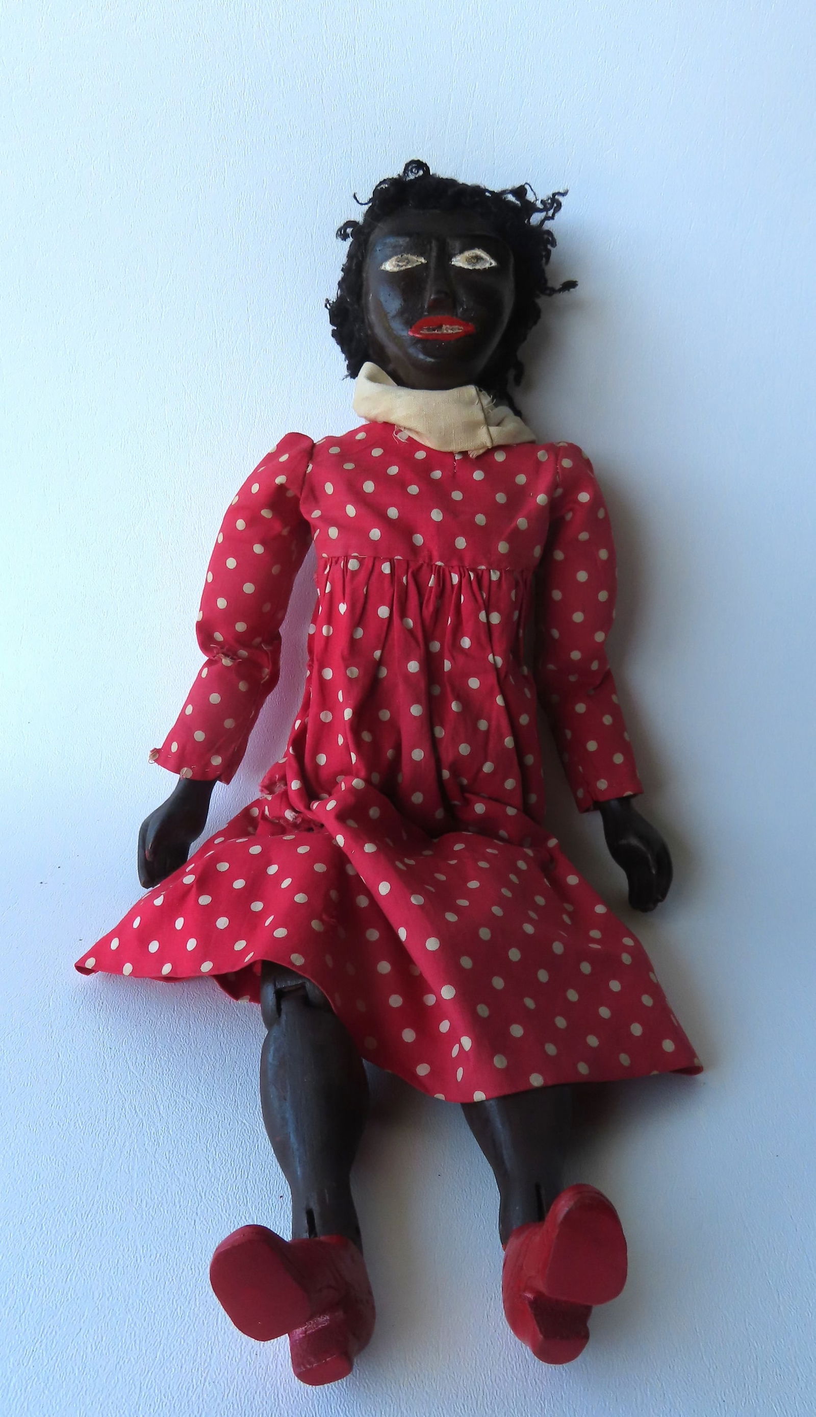 A hand carved and painted Black doll with jointed body, original paint, probably late 19th century. (1 of 8)