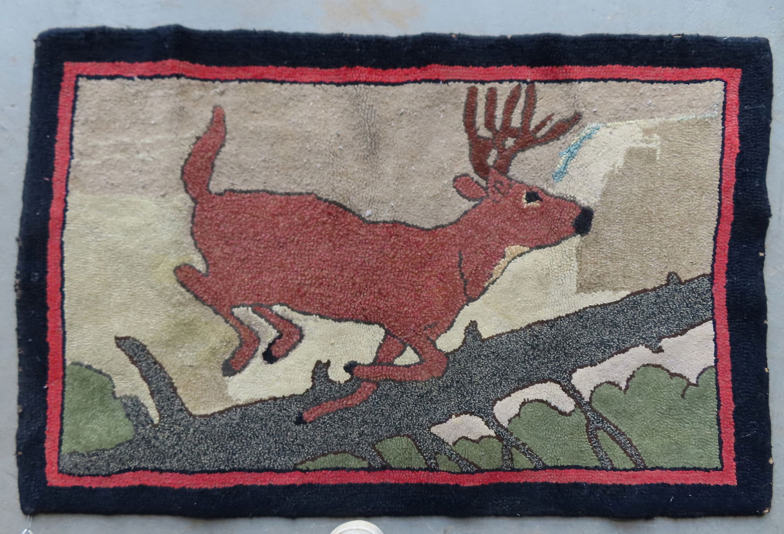 Pictorial hooked rug depicting a stag leaping over a fallen pine tree, probably mid 20th century. (1 of 5)