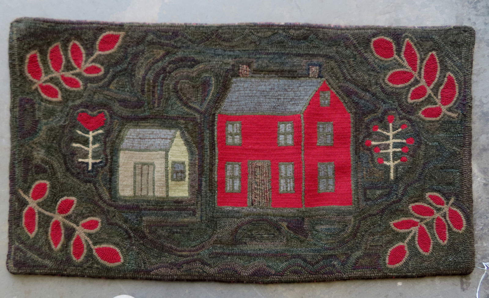 A folk art hooked rug  decorated with 2 buildings, a heart above the smaller building, flanked by 2 (1 of 4)