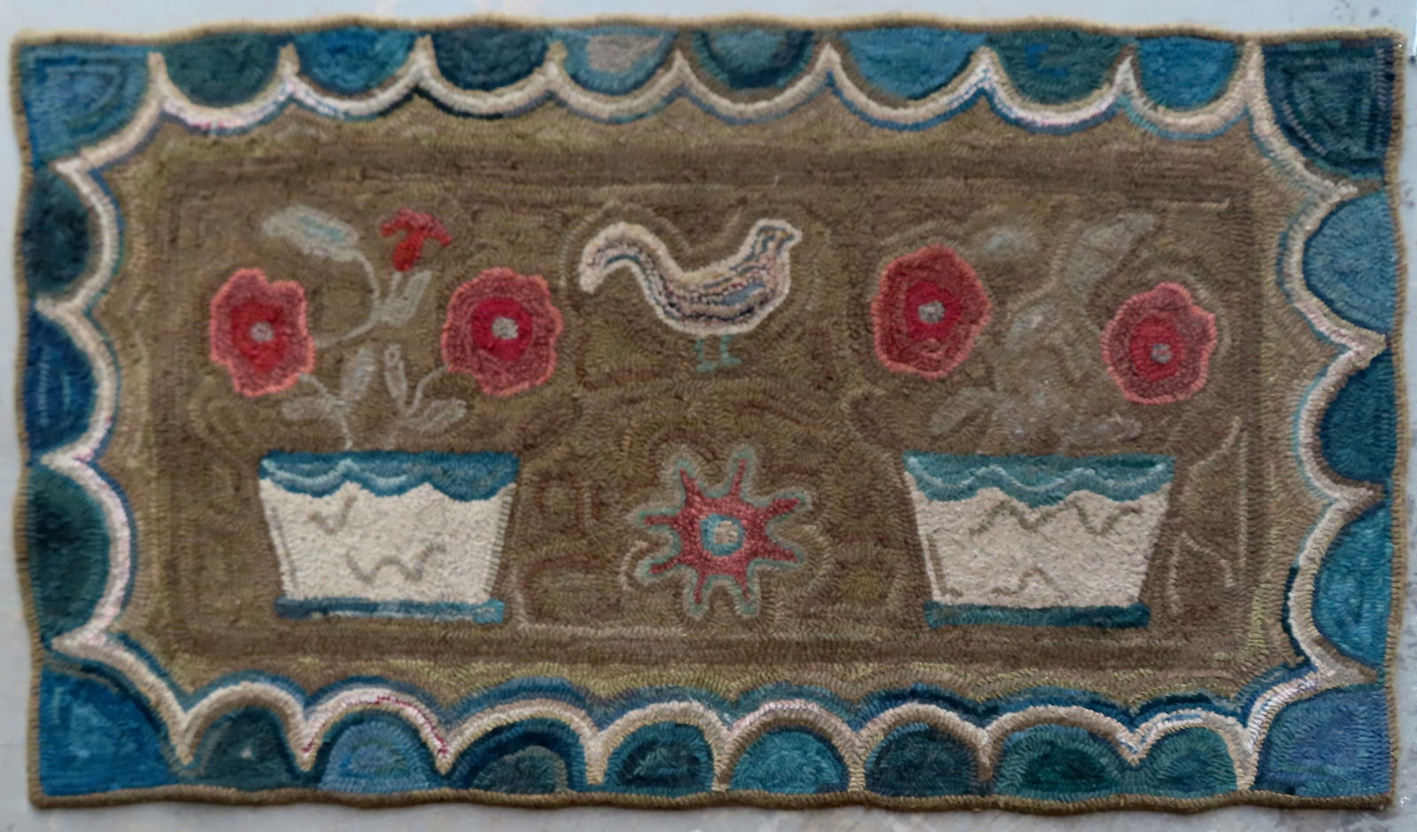 An exceptional folk art hooked rug decorated with 2 pots of flowers separating a gamecock above a (1 of 5)