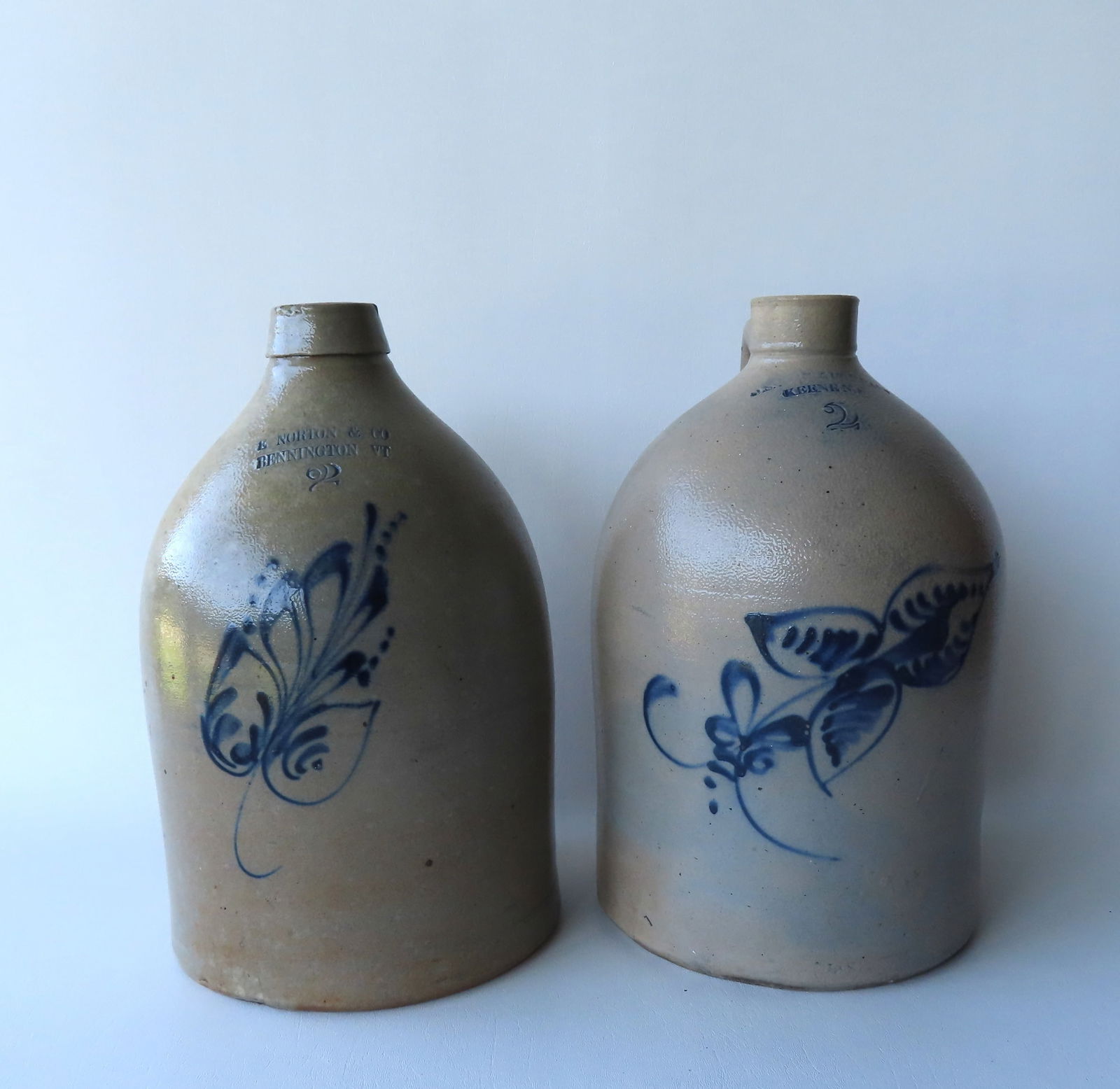Two stoneware 2 gallon jugs. The first decorated with cobalt blue foliage, with the impressed mark (1 of 11)