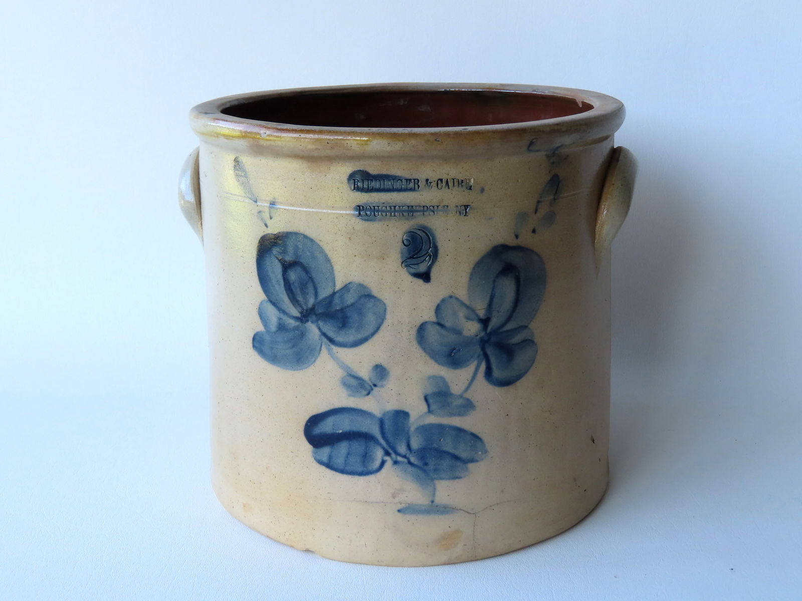 A stoneware crock, 2 gallon, decorated with a cobalt blue double flower, with the impressed mark of (1 of 8)