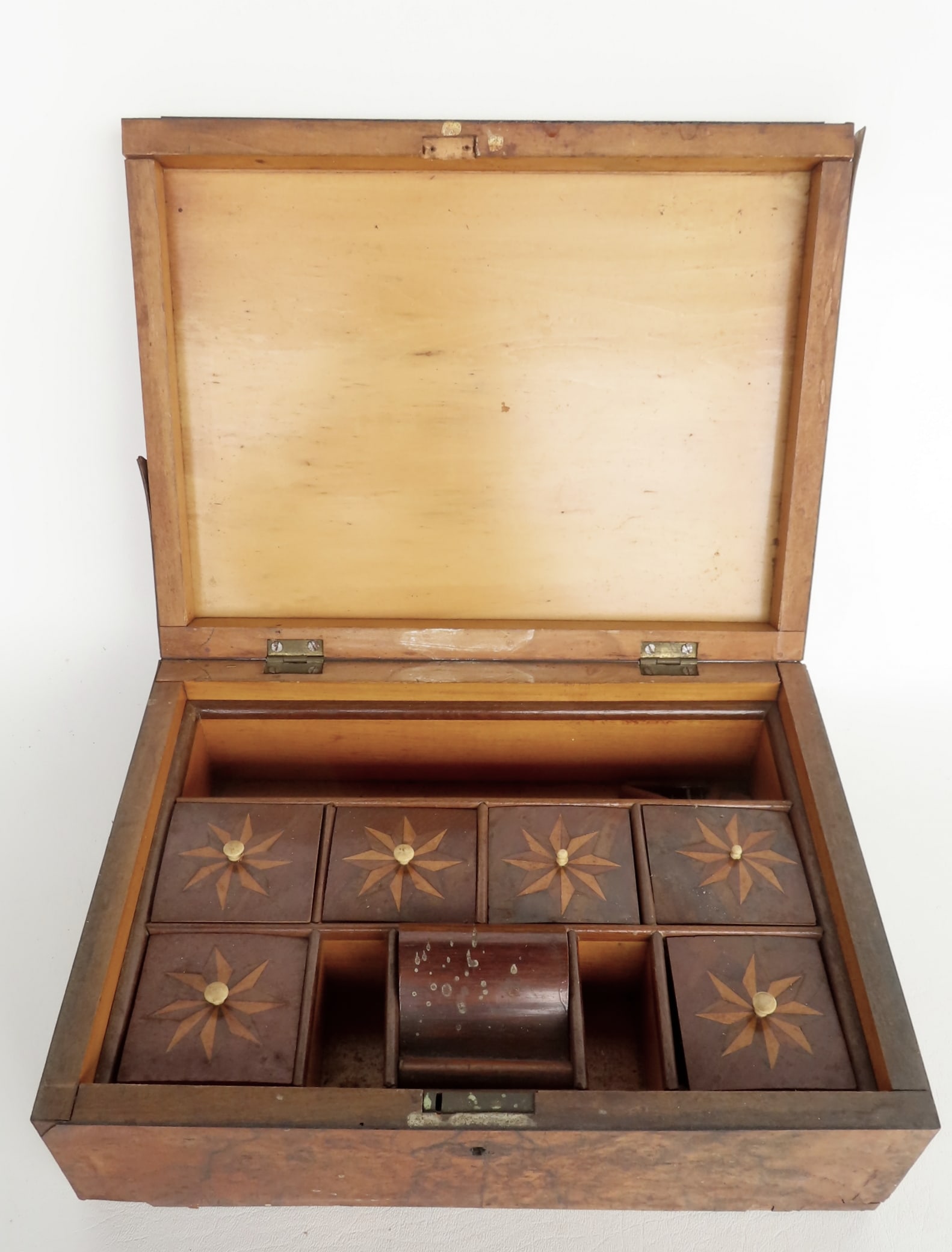 A 19th century sewing box having a dovetailed burlwood case and having a fitted interior compartment: A 19th century sewing box having a dovetailed burlwood case and having a fitted interior compartment consisting of a hidden pin cushion and 6 interior sewing compartments with original lids with pinwh