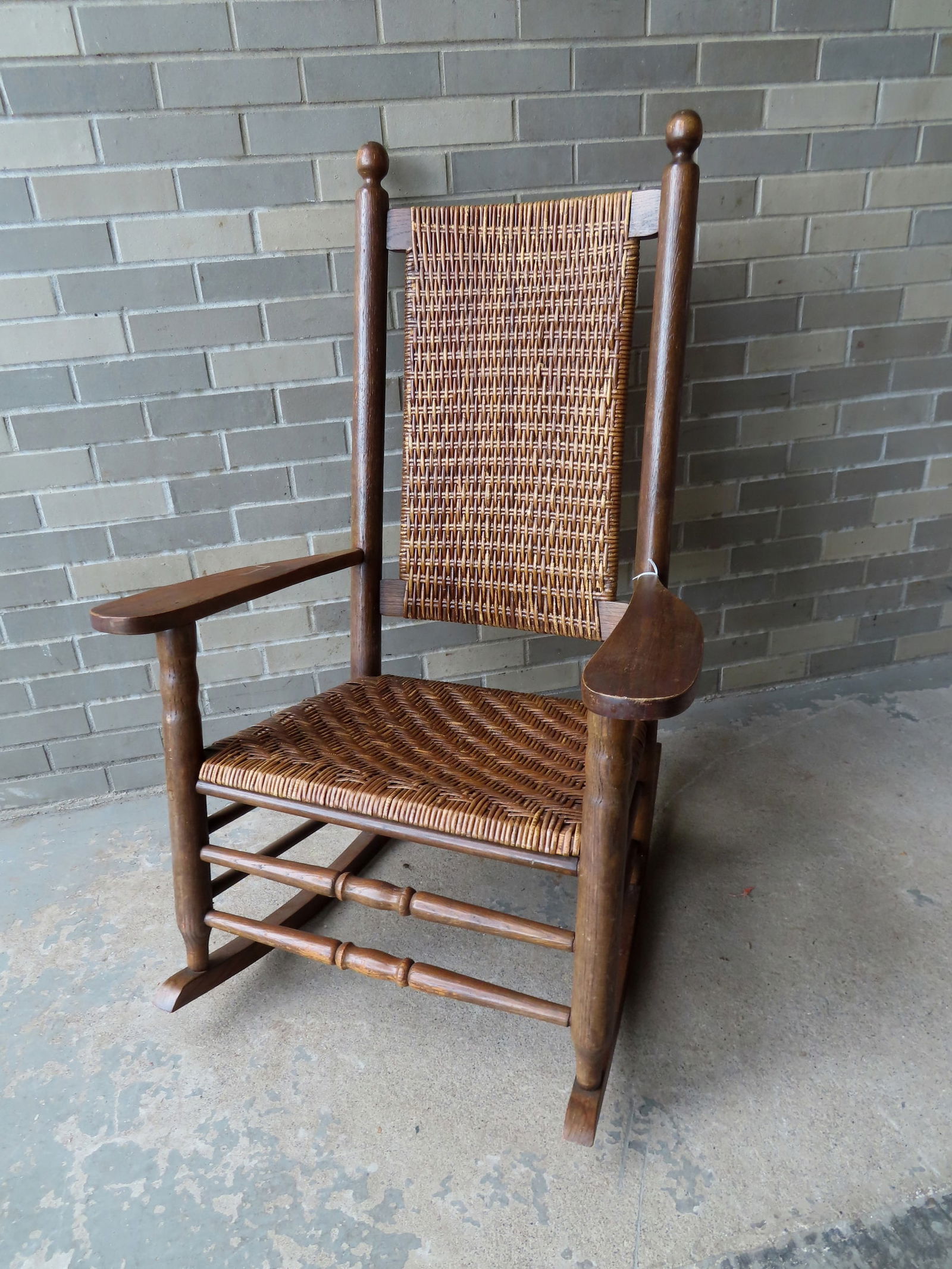 A large vintage porch rocker with arms and woven cane seat and back in very good condition, mid 20th (1 of 4)