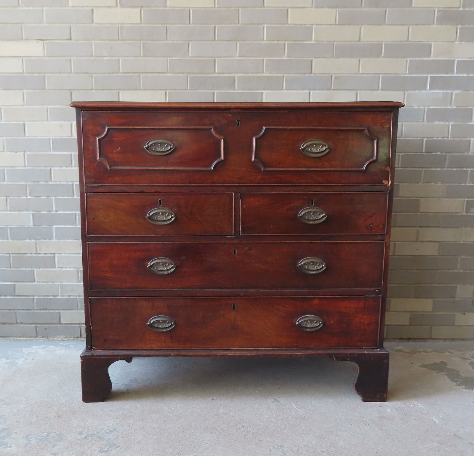 A Chippendale mahogany butler's chest having 5 drawers mounted on bracket base. The draw fronts with (1 of 20)