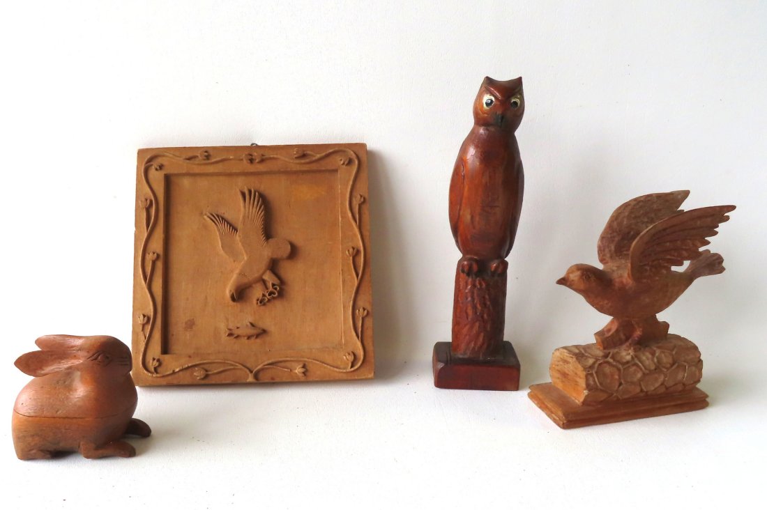 A grouping of 4 carved folk art figures. (1 of 9)