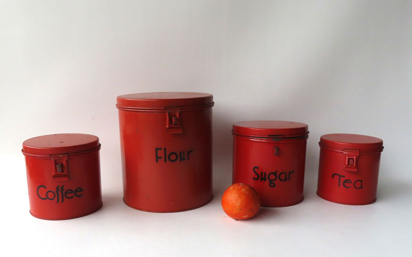 A nested set of 4 painted tin kitchen storage cannisters signed Kreamer. (1 of 4)