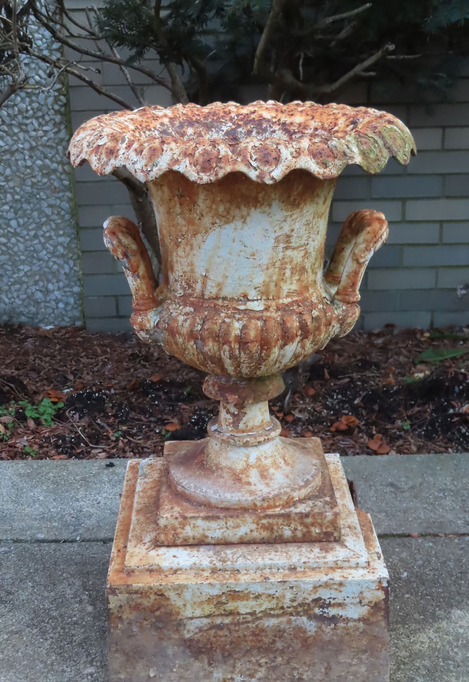 A cast iron garden urn in 3 parts - the top  section with double handles and having a horse-shoe (1 of 8)