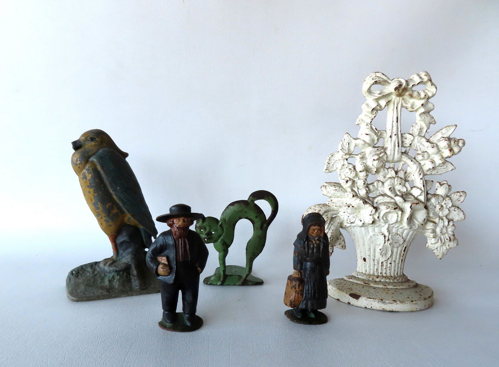 Grouping of cast iron figures including: Parrot door stop in original paint - chip to end of beak - (1 of 9)